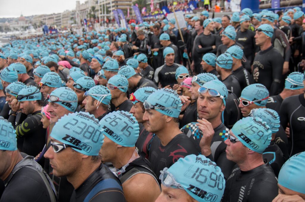 Athletes nervously await the swim start of an Ironman