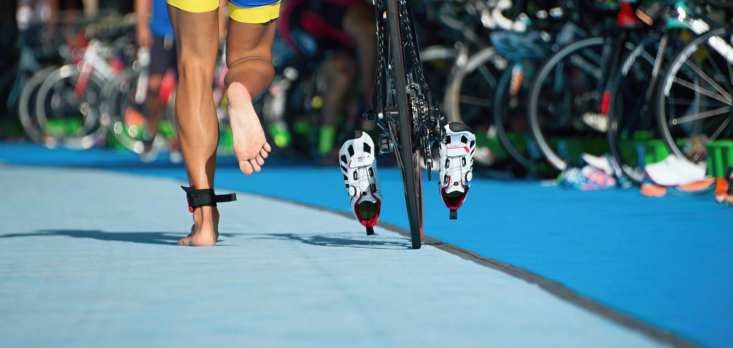 Triathlon bike the transition zone, the triathlonist runs on a bicycle