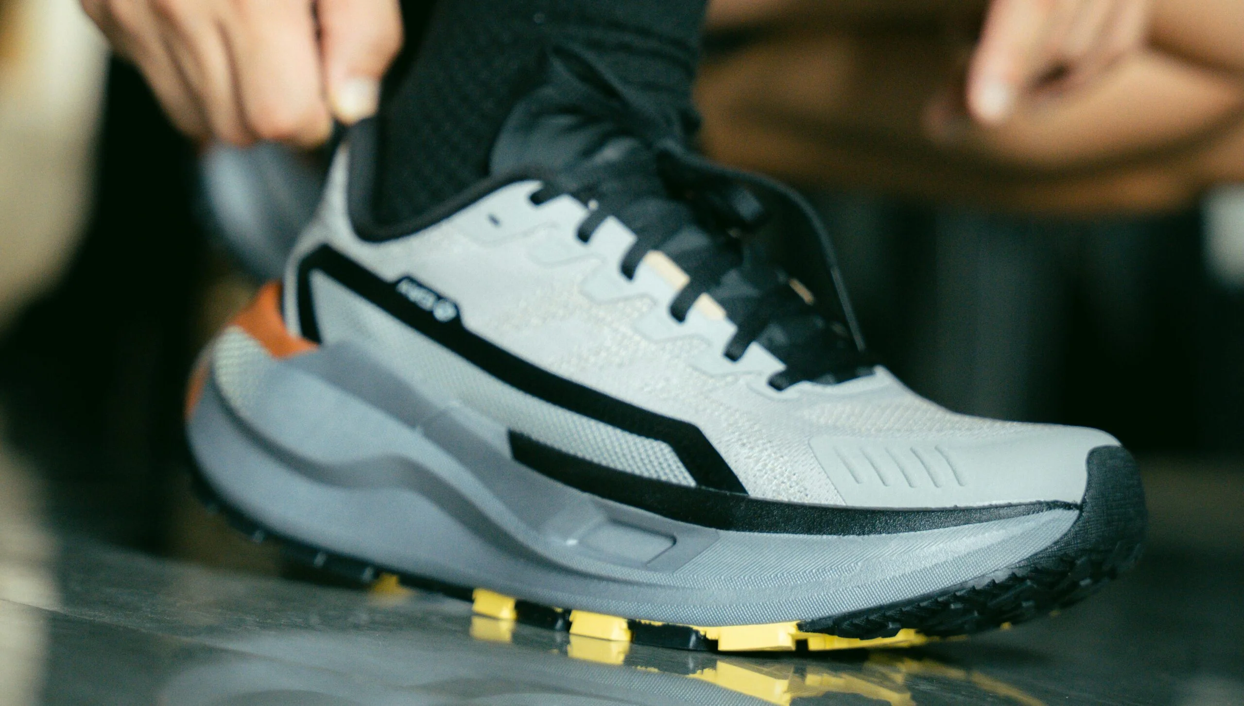 A carbon plated running shoe being put on by a triathlete